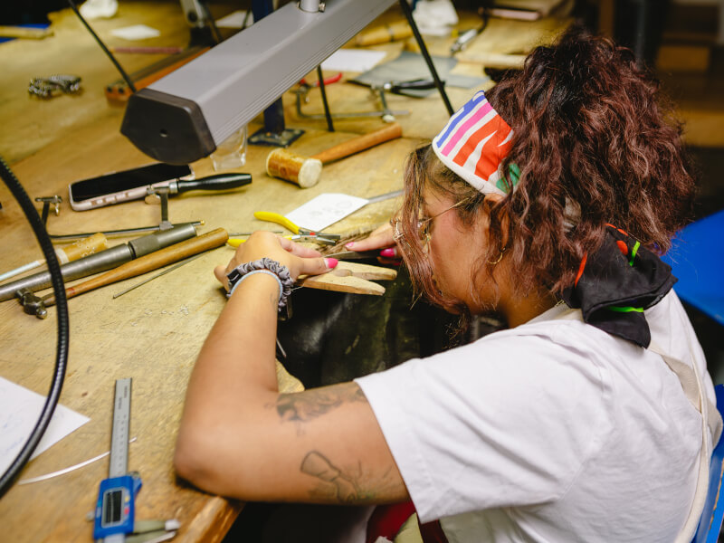 A person working at a jewellery making class